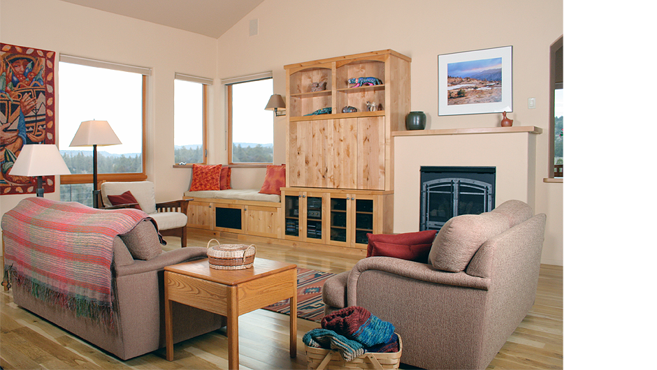 Criss Cross Living Room Living room with fireplace and sustainable, built-in window seat and cabinets